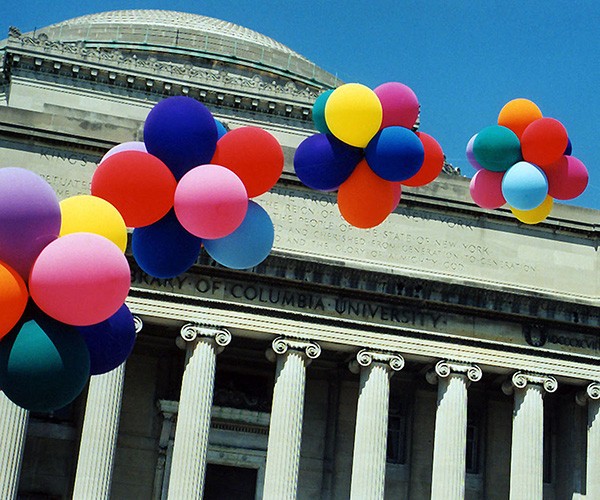 Low Library on Columbia University's Morningside campus with a spray of balloons floating by