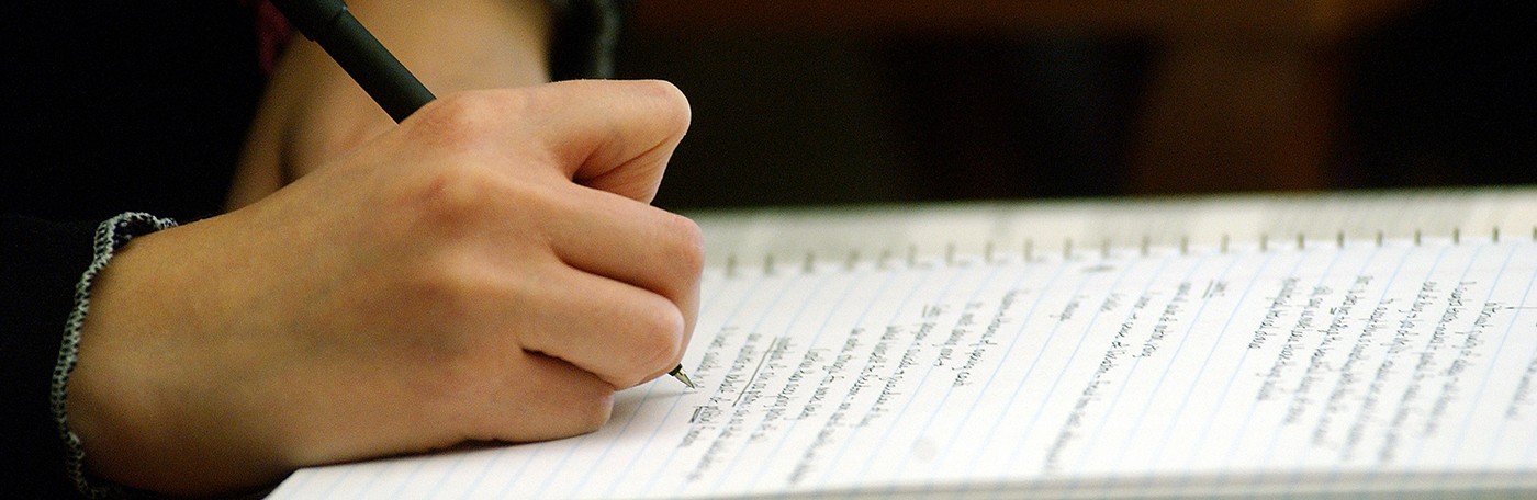 Close up image of student taking a written exam