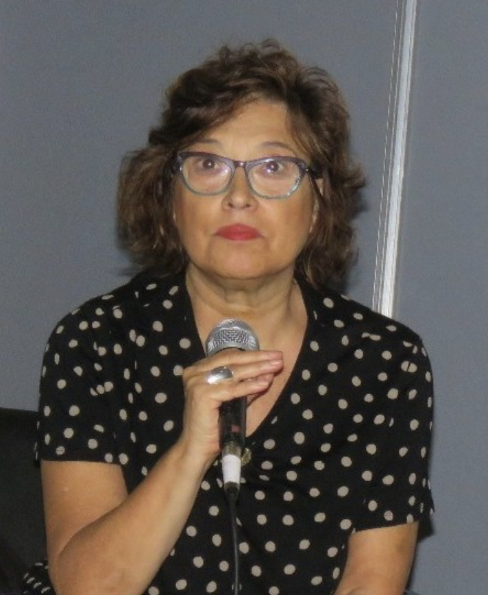 Nora Dominguez holding a microphone