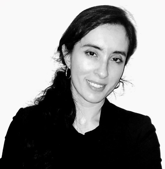 Black and white picture of Romina wearing a black blazer