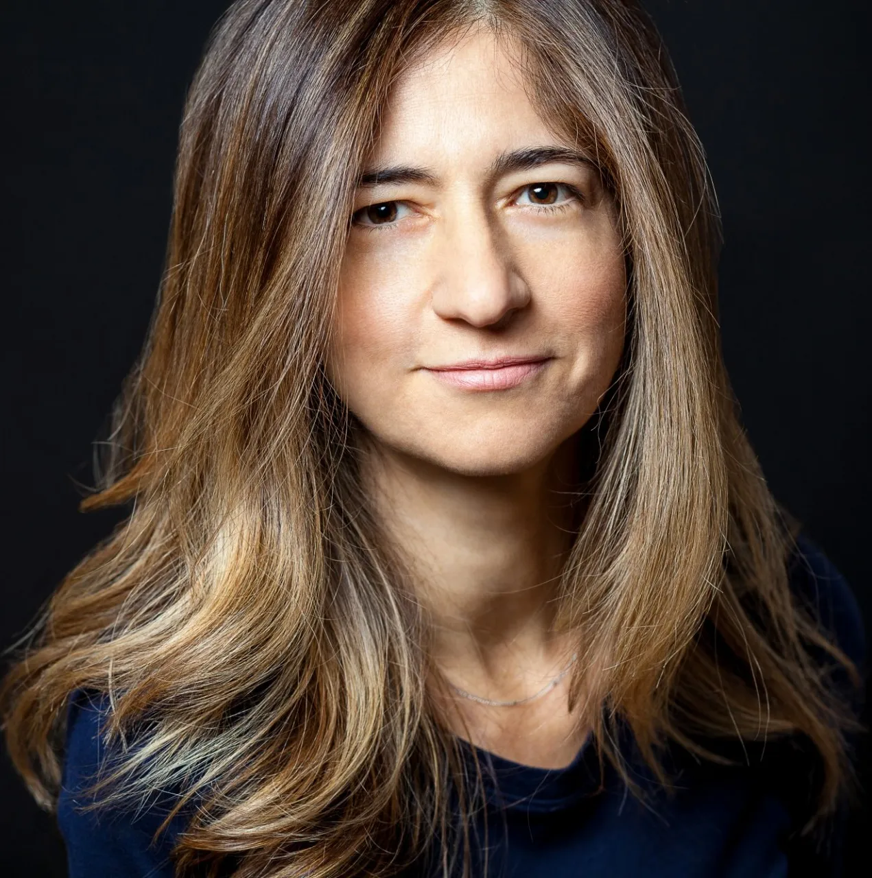 Frances is wearing a navy blue and long-sleeve shirt.
