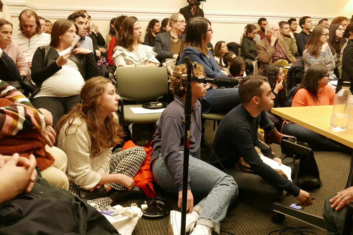 A group of people sit in a classroom